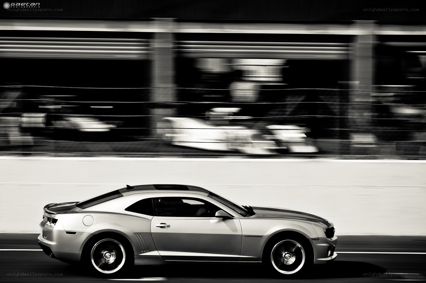 Silver Camaro racing on track