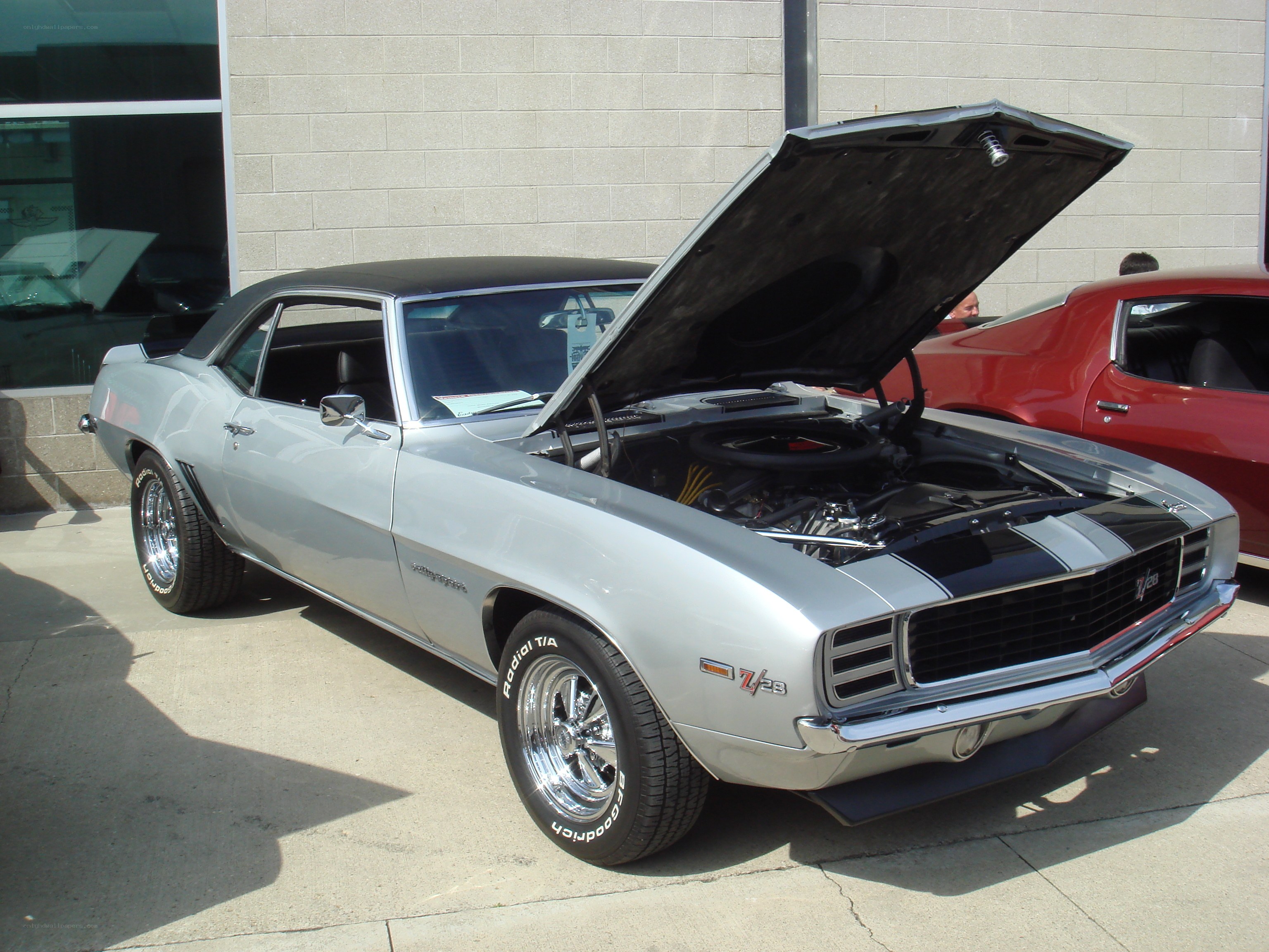 Silver Camaro with open hood