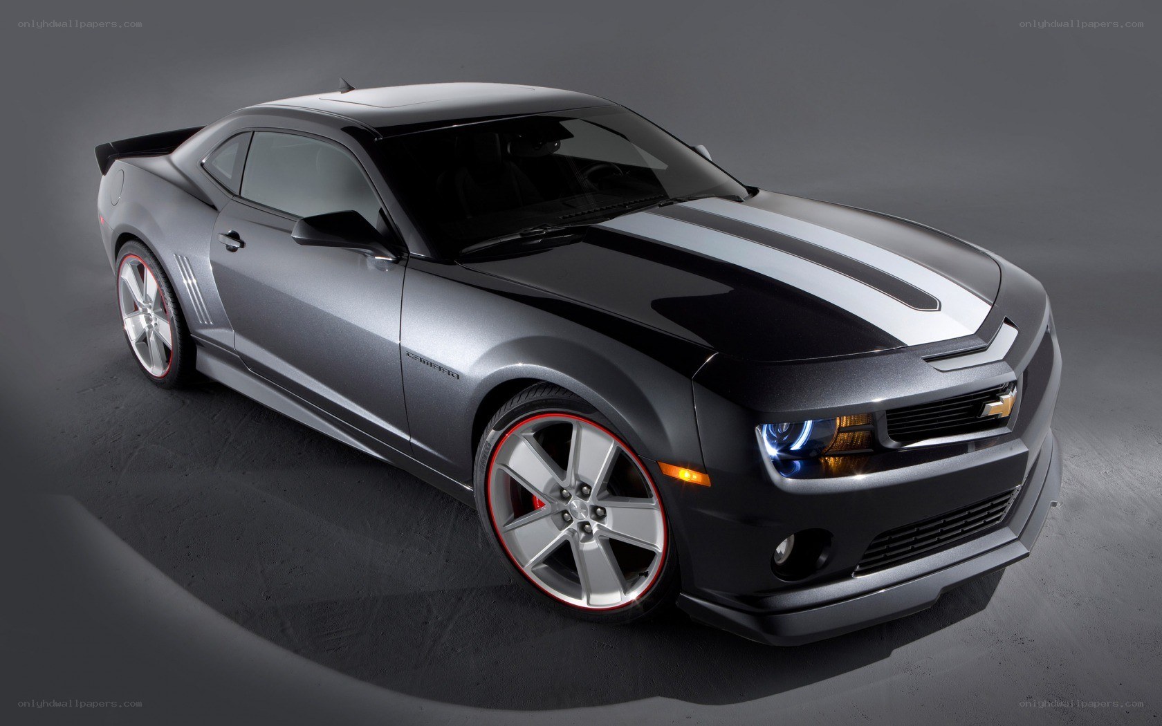 Silver Camaro with racing stripes
