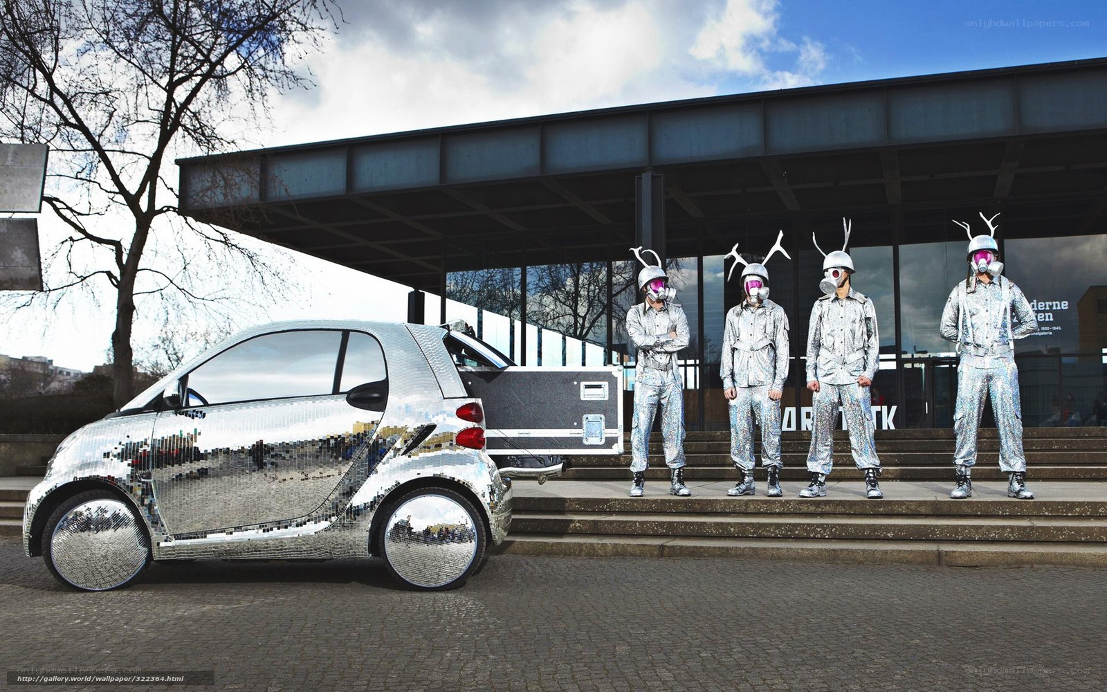 Silver car and costumed performers