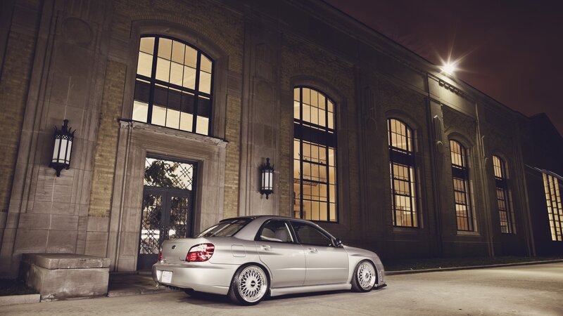 silver car at night by building