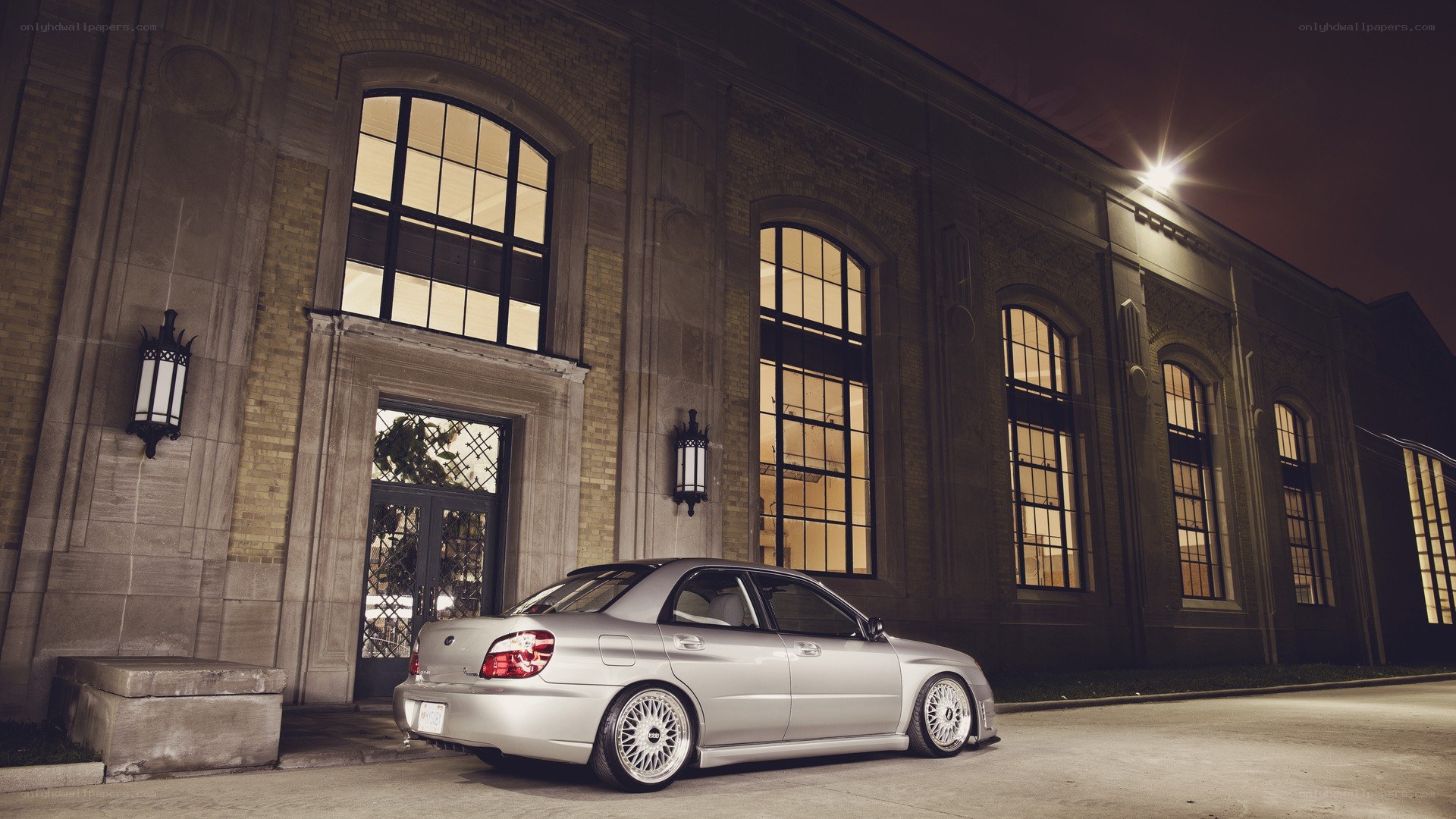 silver car at night by building