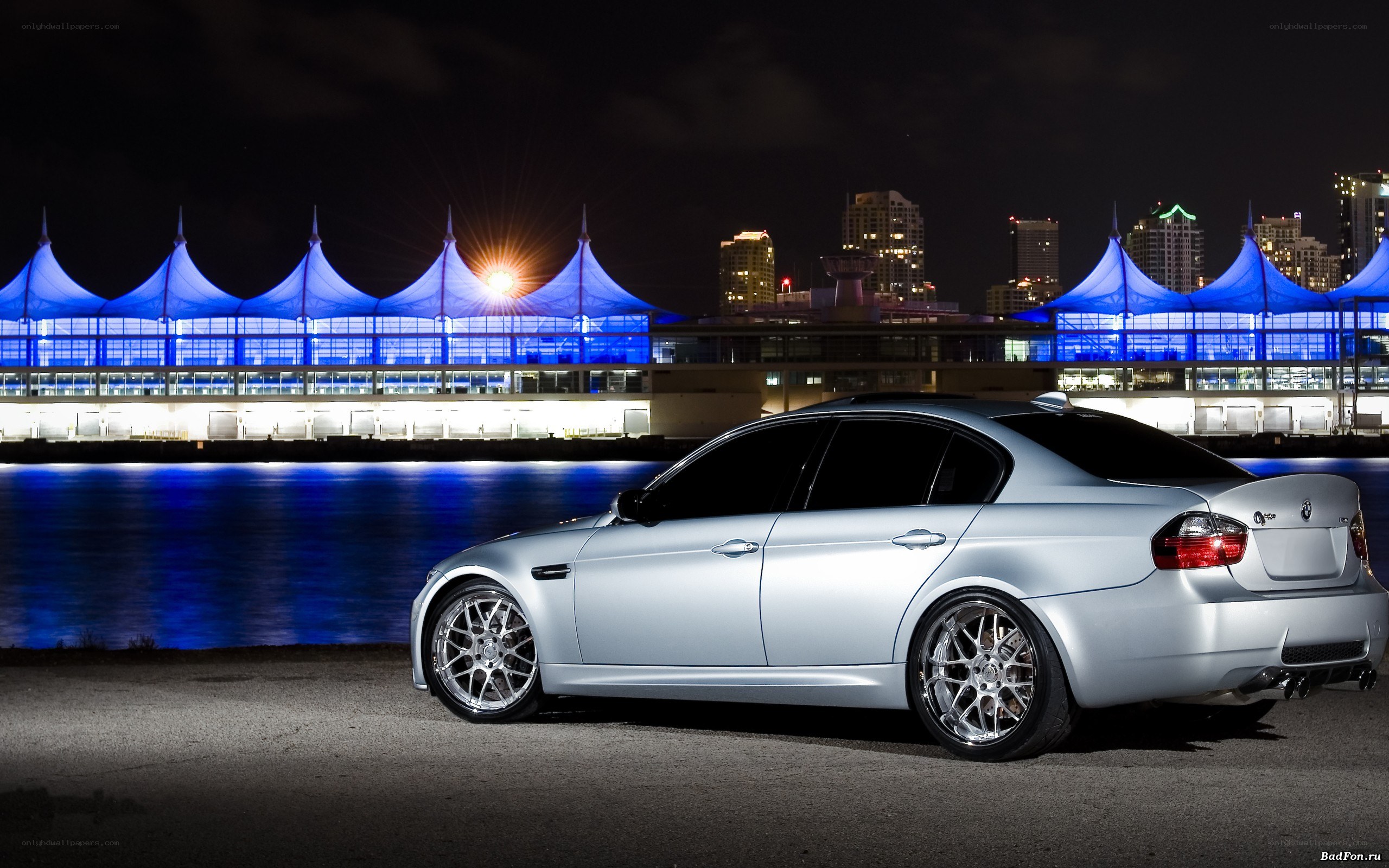 silver car at night by water