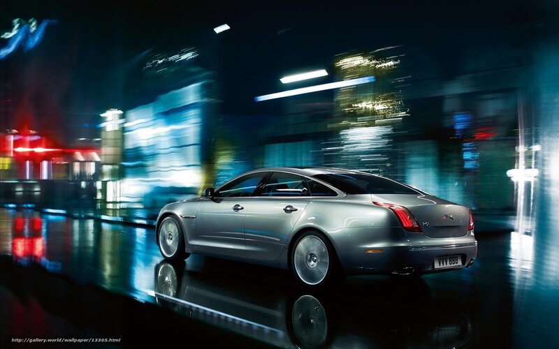 Silver car at night in city