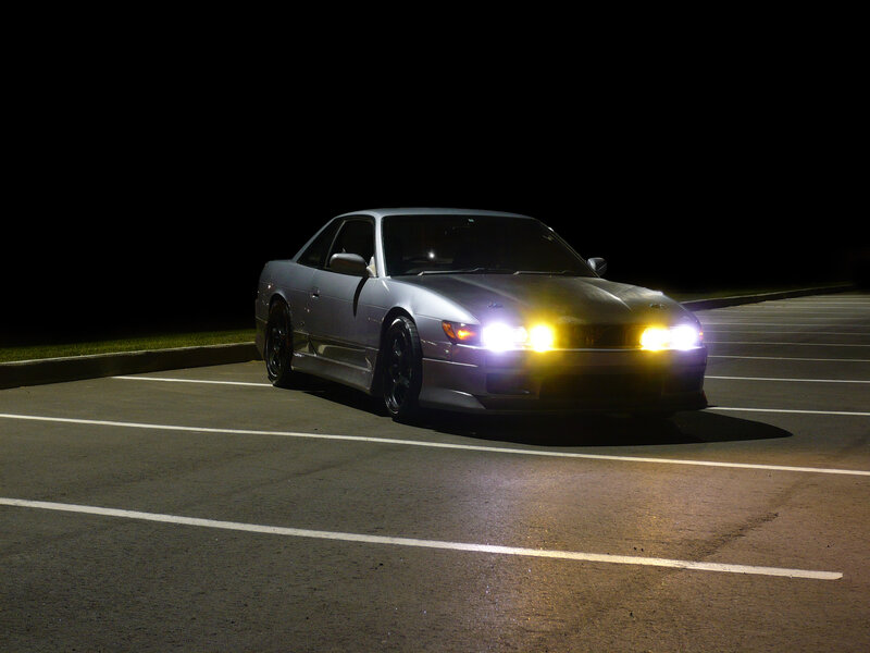silver car at night in parking lot