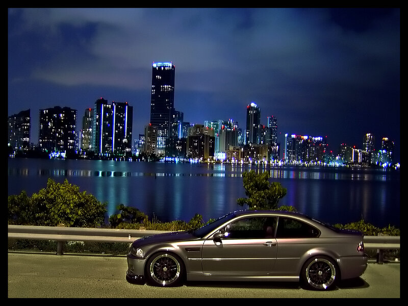 silver car at night with city skyline