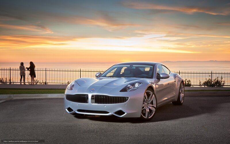 Silver car at sunset by the sea