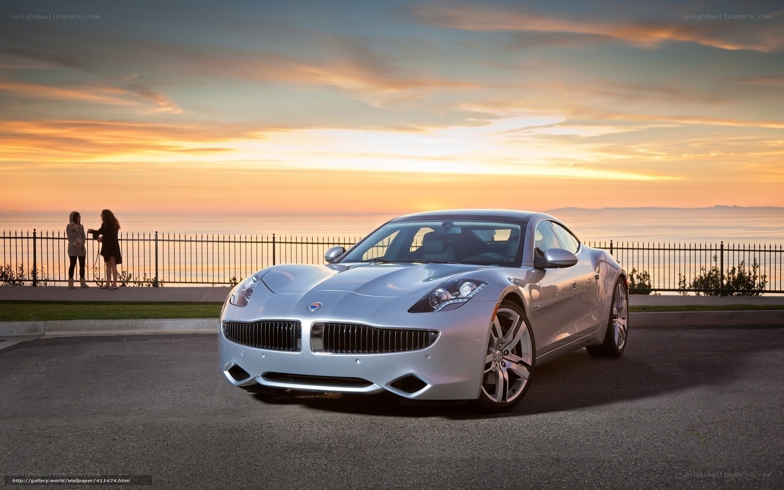 Silver car at sunset by the sea