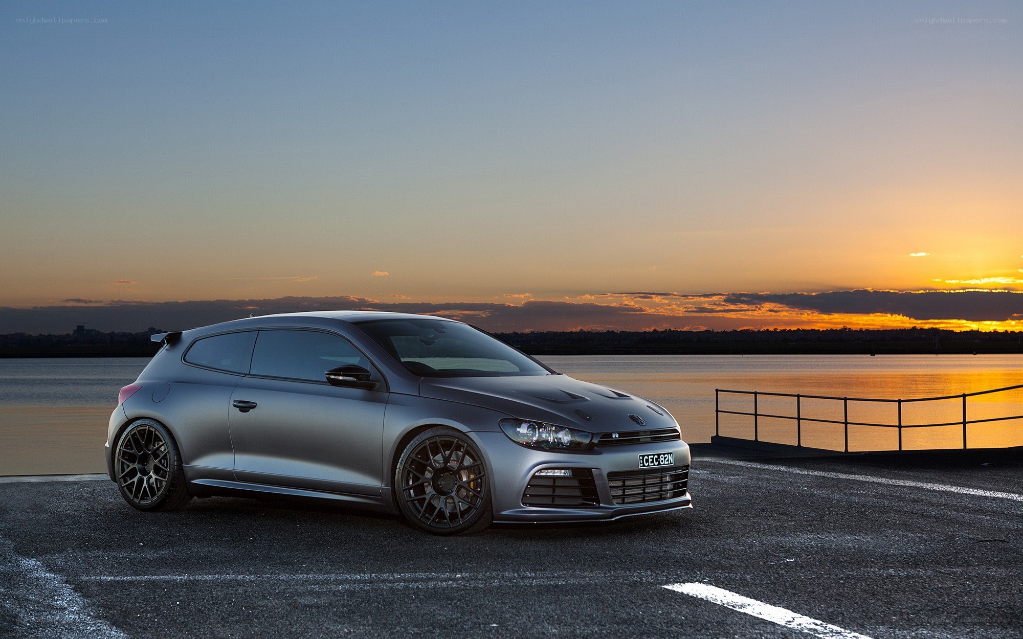silver car at sunset by water