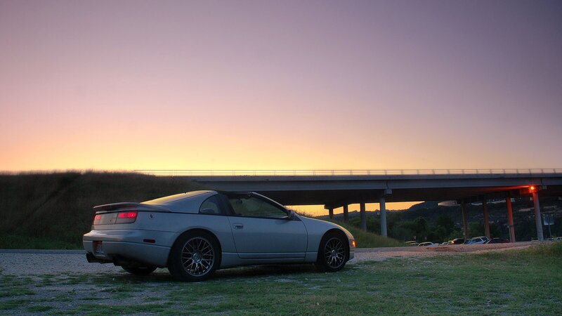 silver car at sunset near bridge
