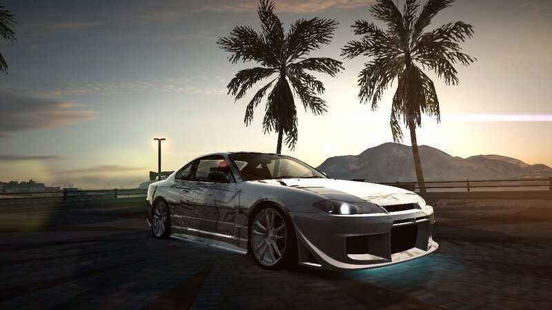 silver car at sunset with palm trees