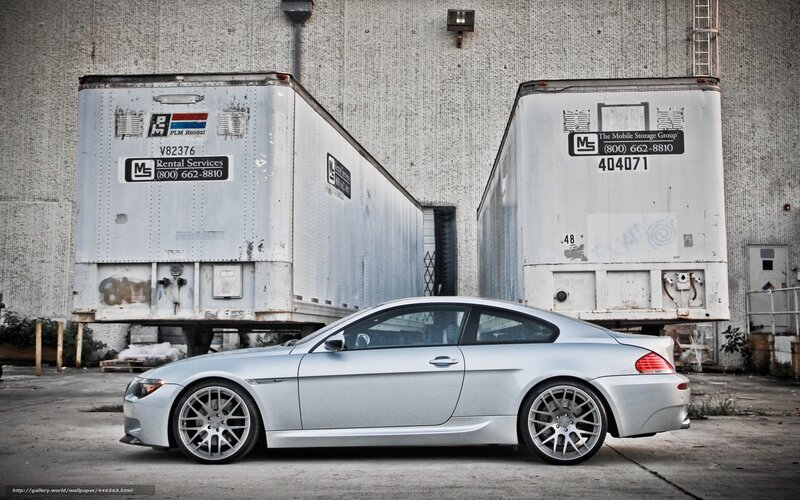 silver car between trailers