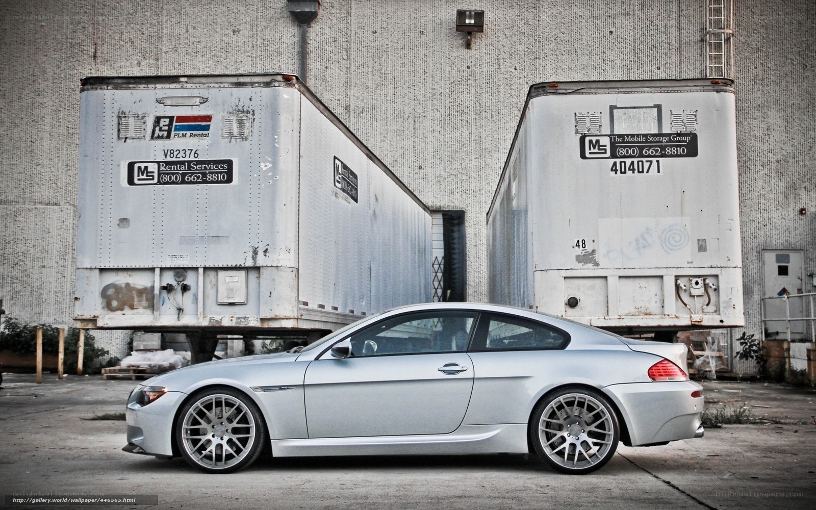 silver car between trailers