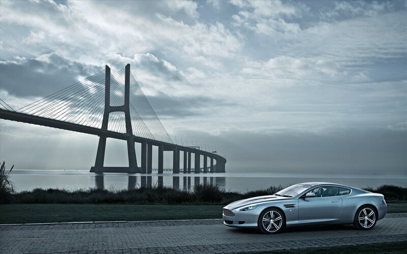 Silver car by a bridge
