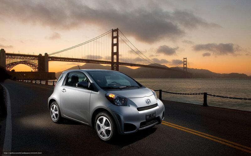 Silver car by Golden Gate Bridge