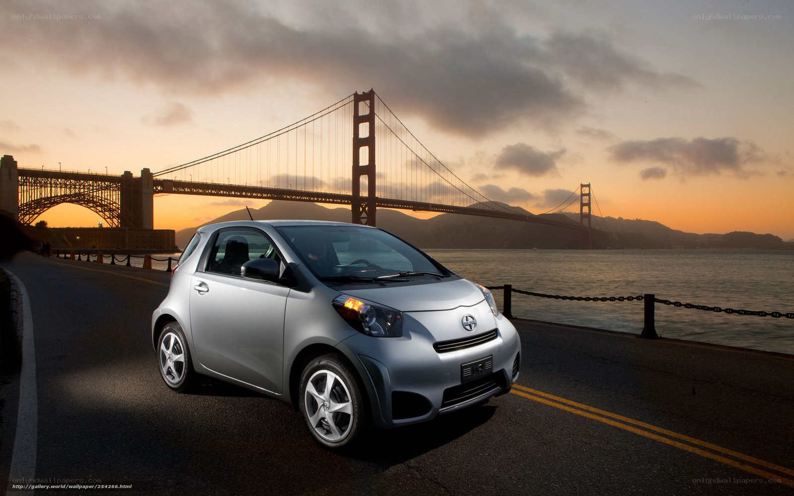 Silver car by Golden Gate Bridge