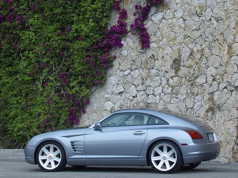 silver car by stone wall