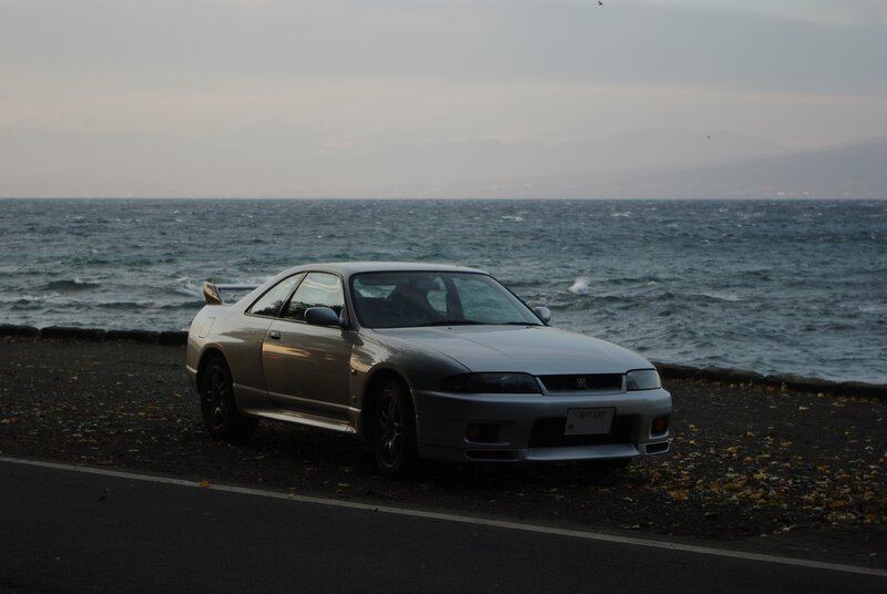 Silver car by the sea