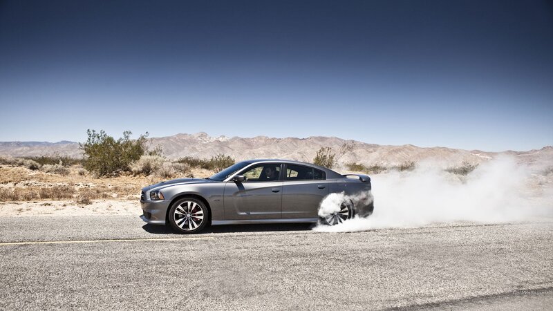 silver car doing burnout