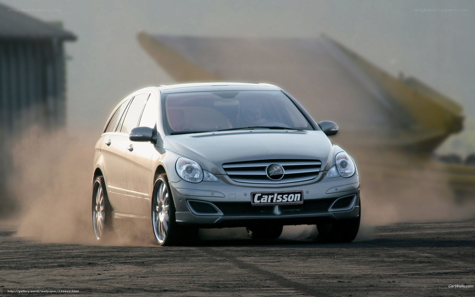 silver car drifting on dirt