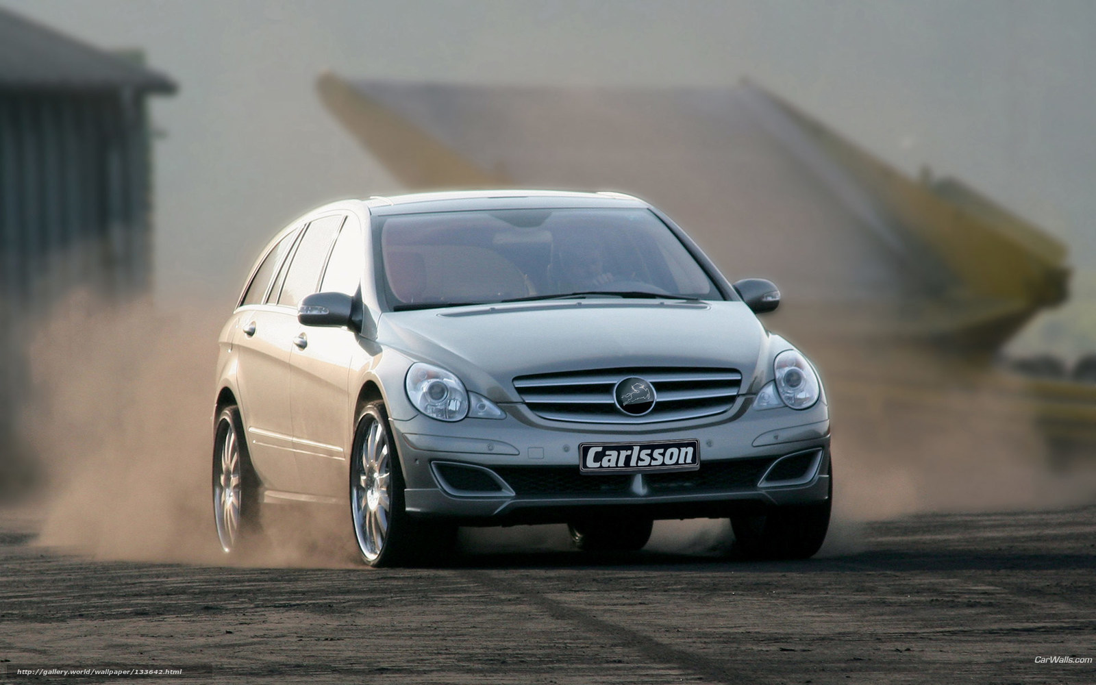 silver car drifting on dirt