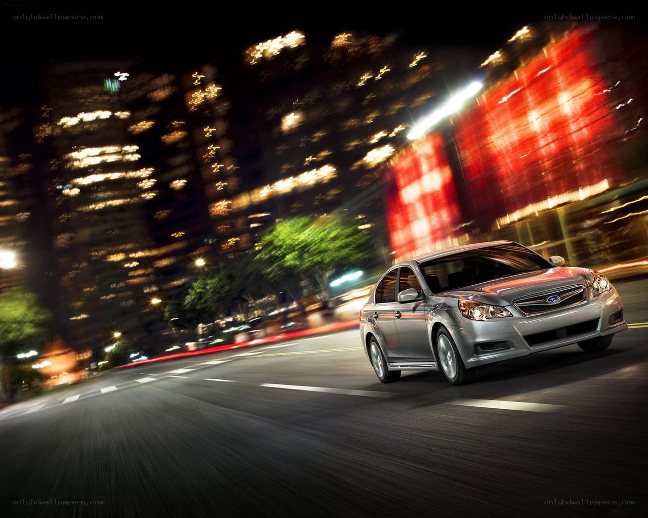 Silver car driving at night