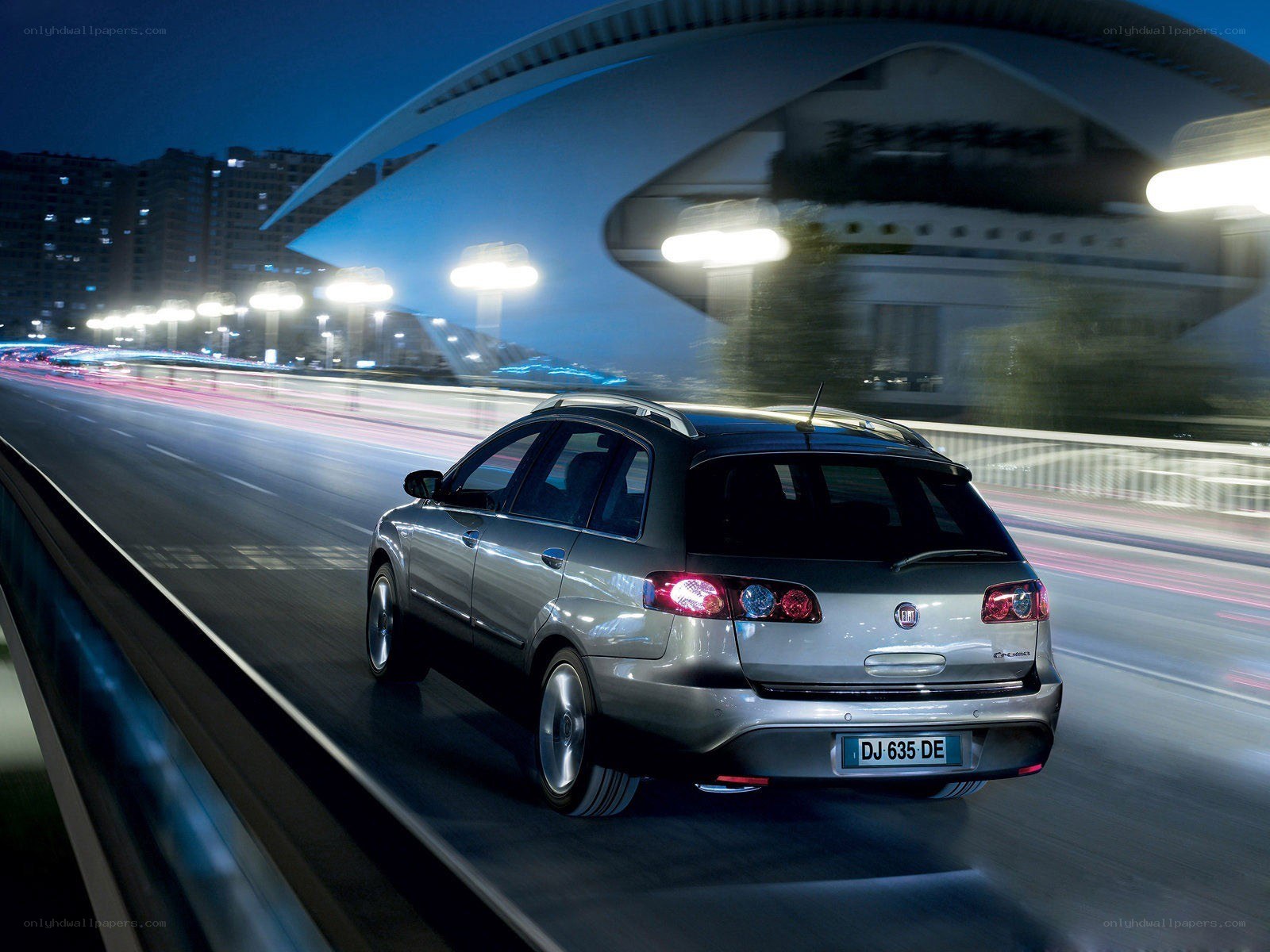 Silver car driving at night
