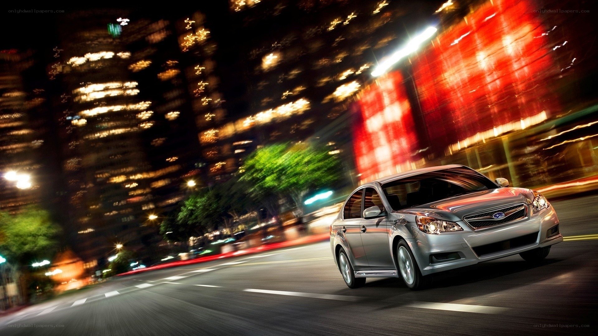 Silver car driving at night