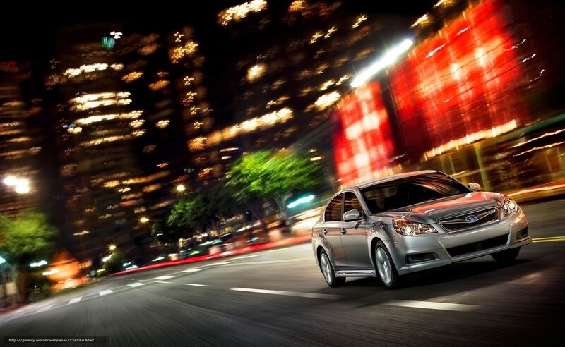 Silver car driving at night