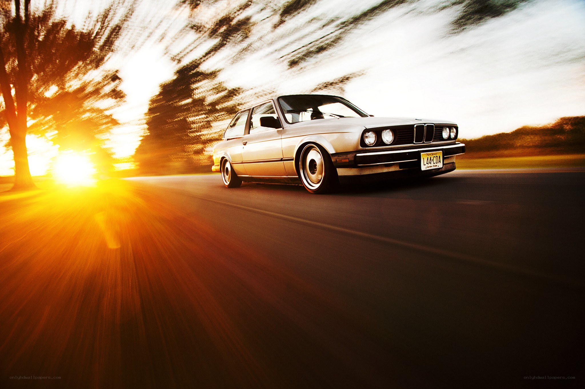 Silver car driving at sunset