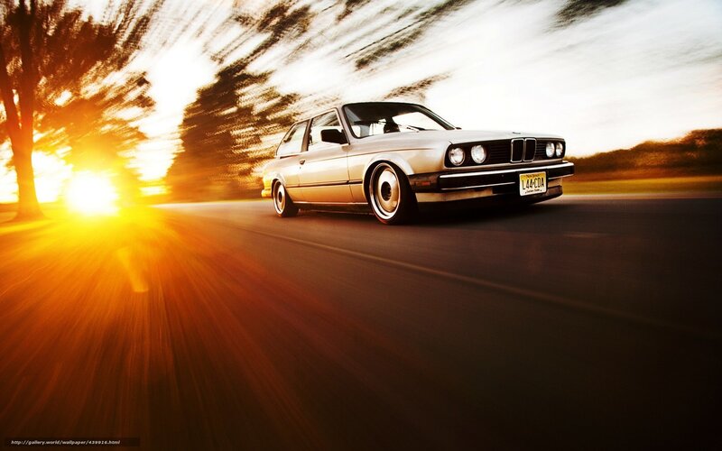 silver car driving at sunset