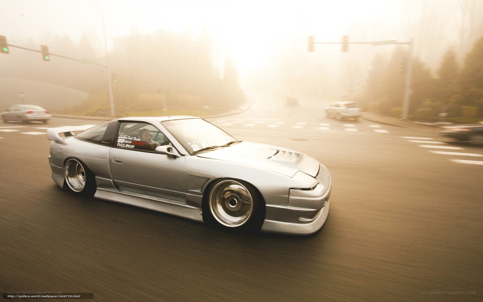 silver car driving in fog