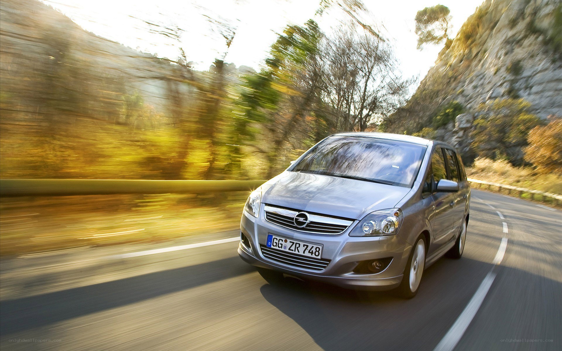silver car driving on mountain road