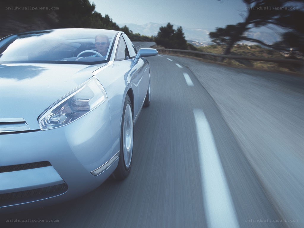 silver car driving on road