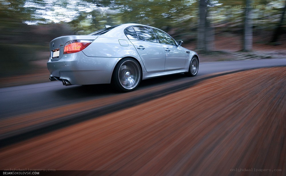 silver car driving on road