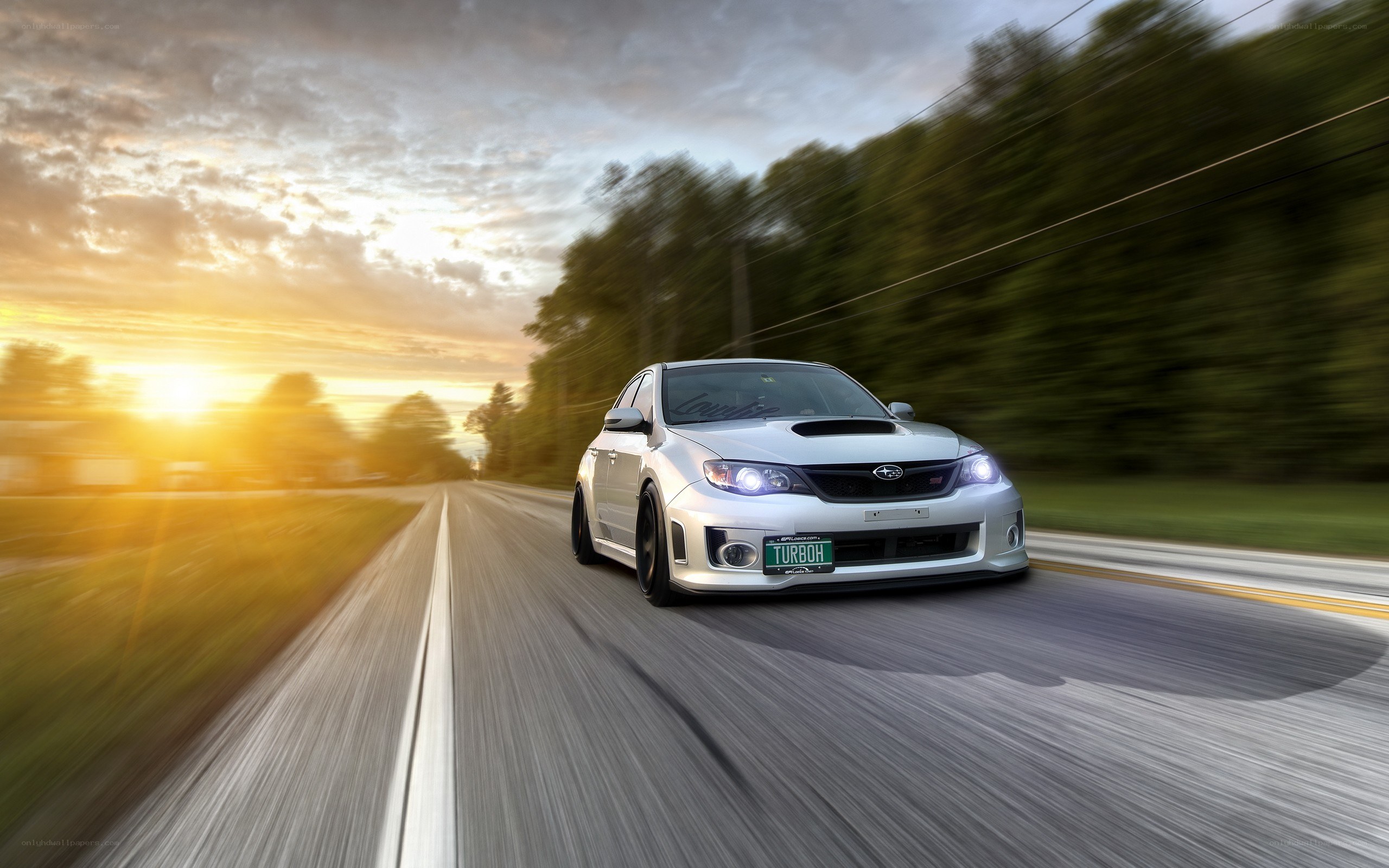 silver car driving on road
