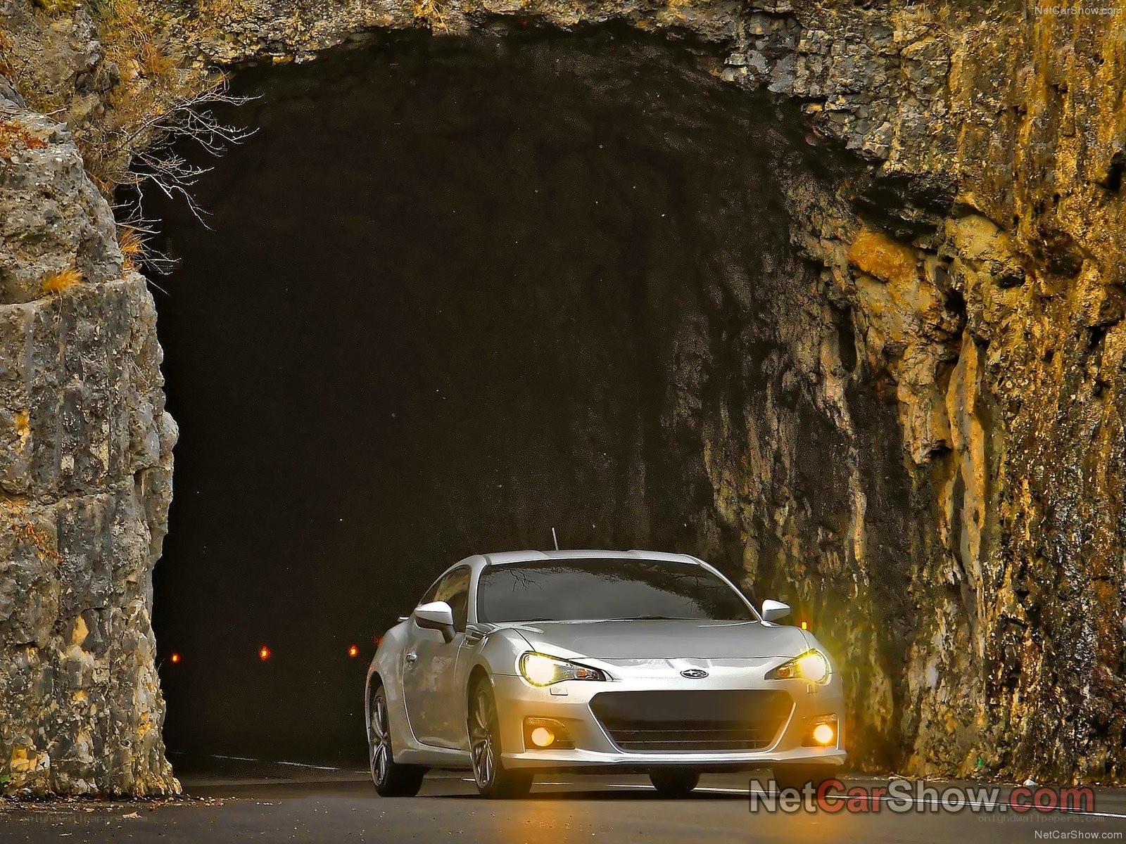 Silver car exiting tunnel