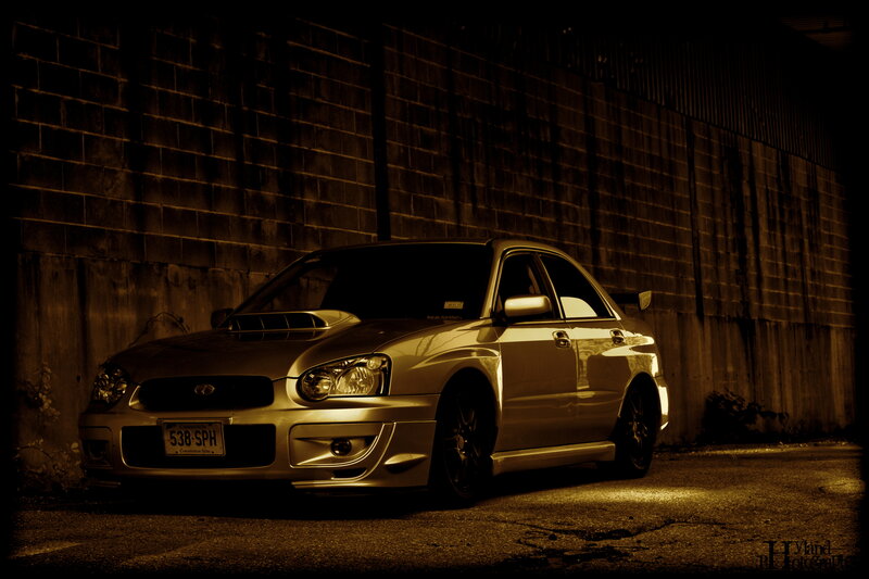 silver car in alley at night