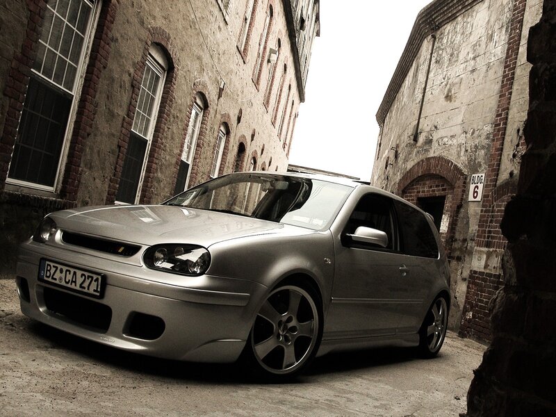 Silver car in alleyway