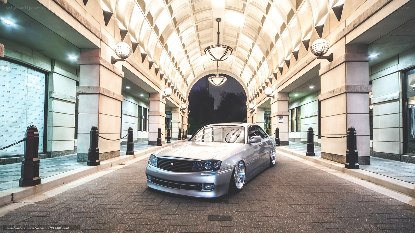 Silver car in an arched tunnel