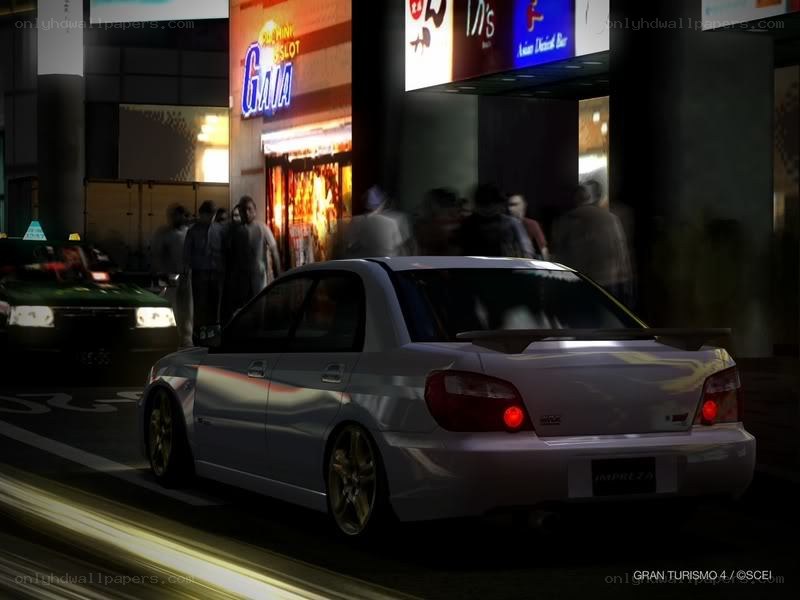 Silver car in city at night