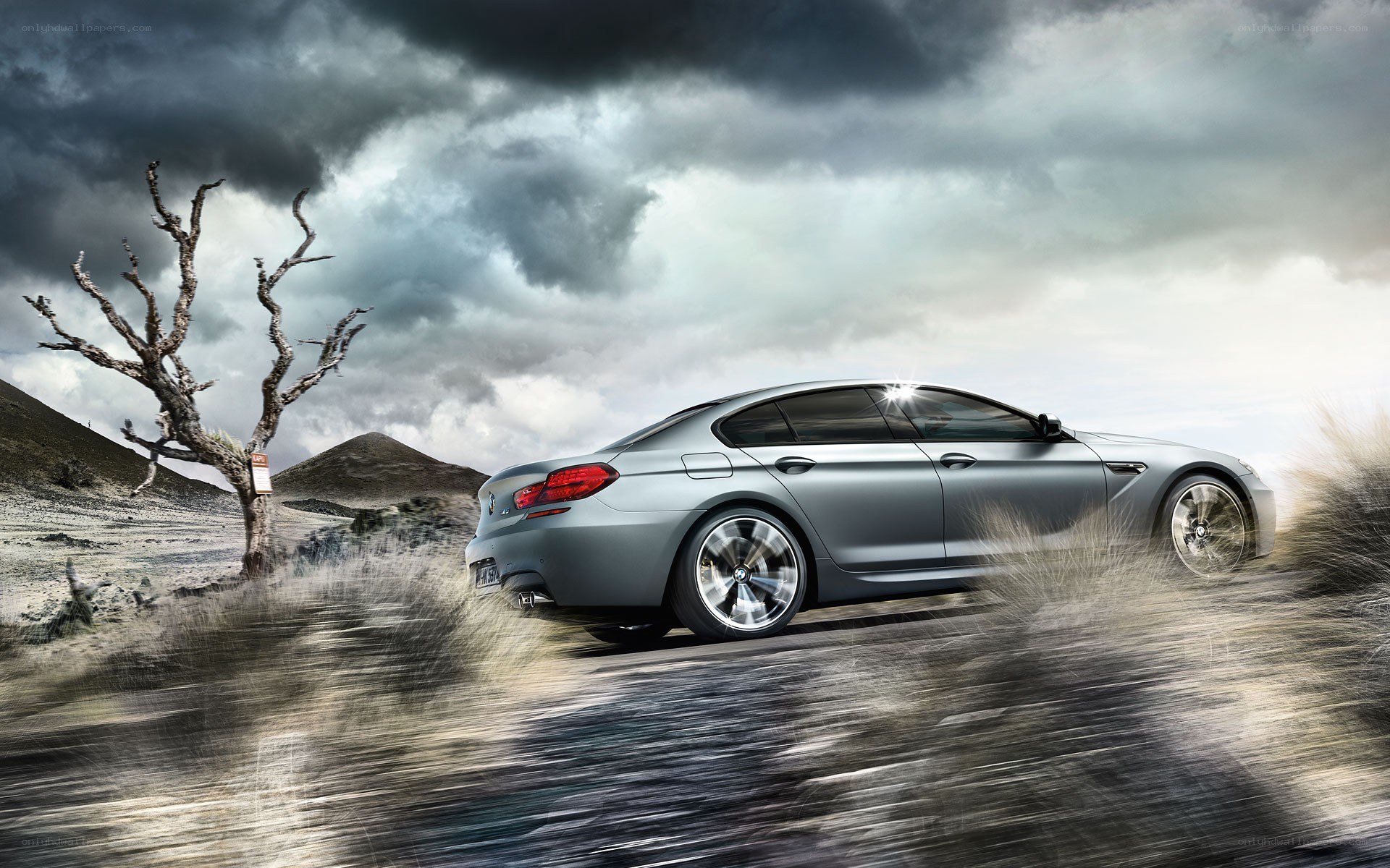 Silver car in desert landscape