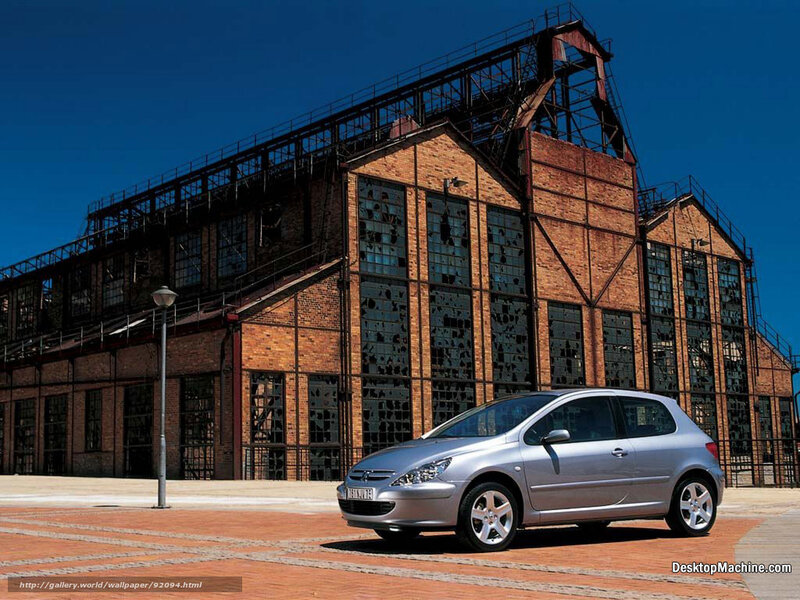 Silver car in front of brick building