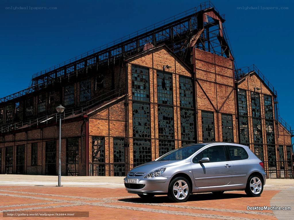 Silver car in front of brick building