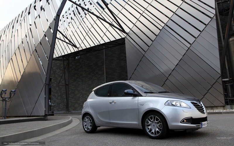 silver car in front of modern building