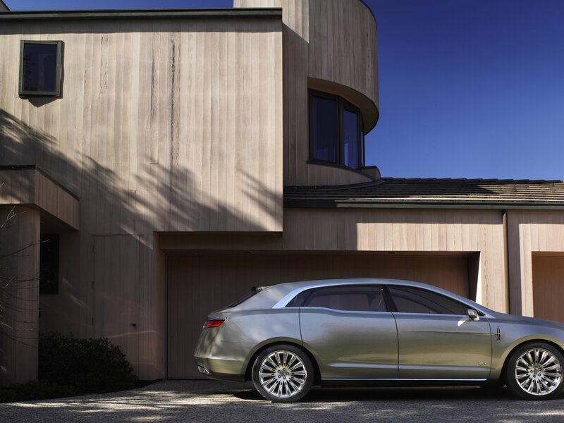 Silver car in front of modern house