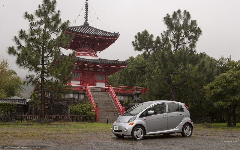 Silver car in front of pagoda