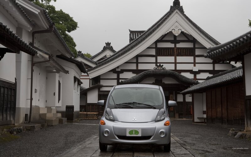 Silver car in traditional Japanese courtyard