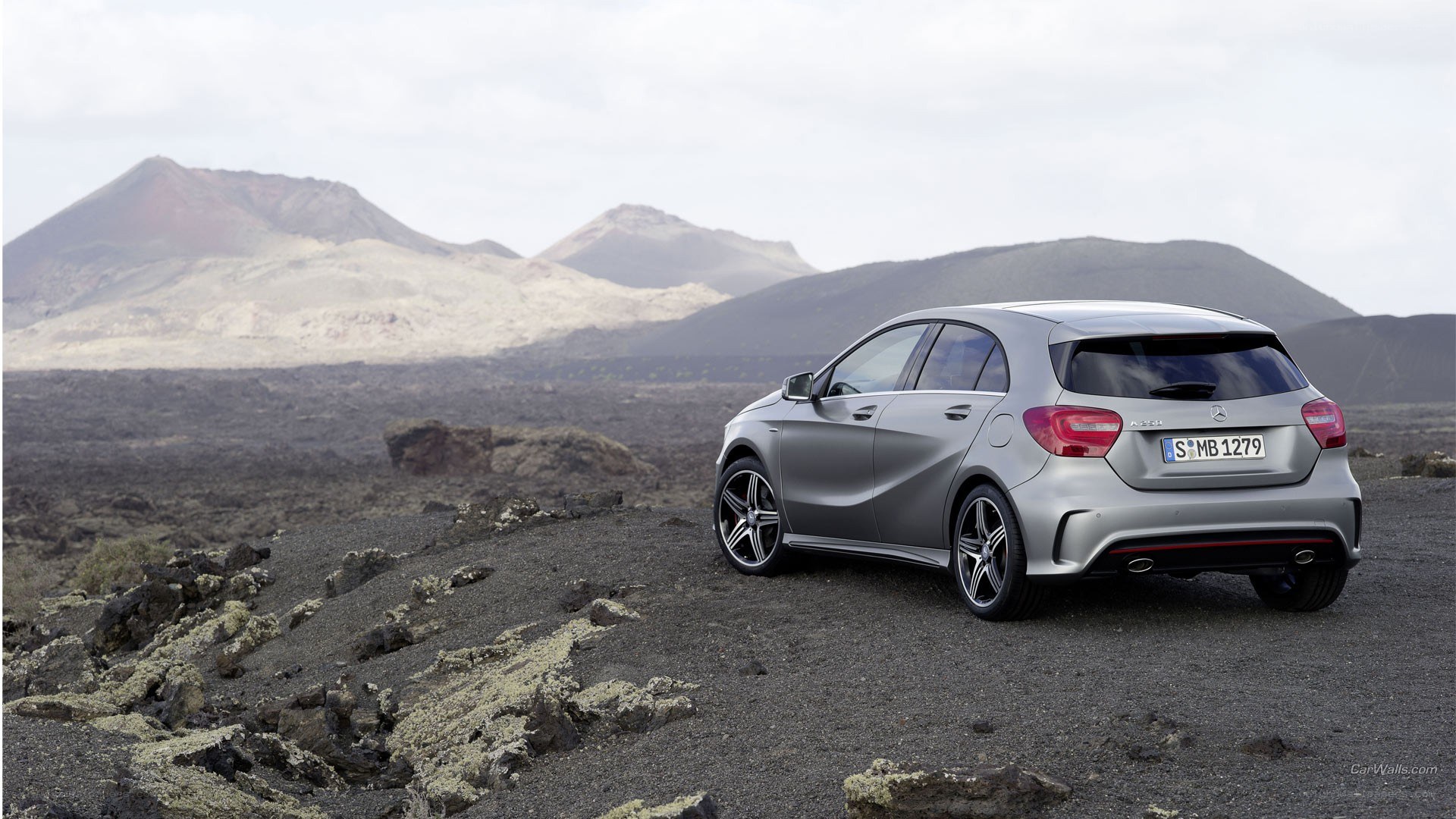 silver car in volcanic landscape
