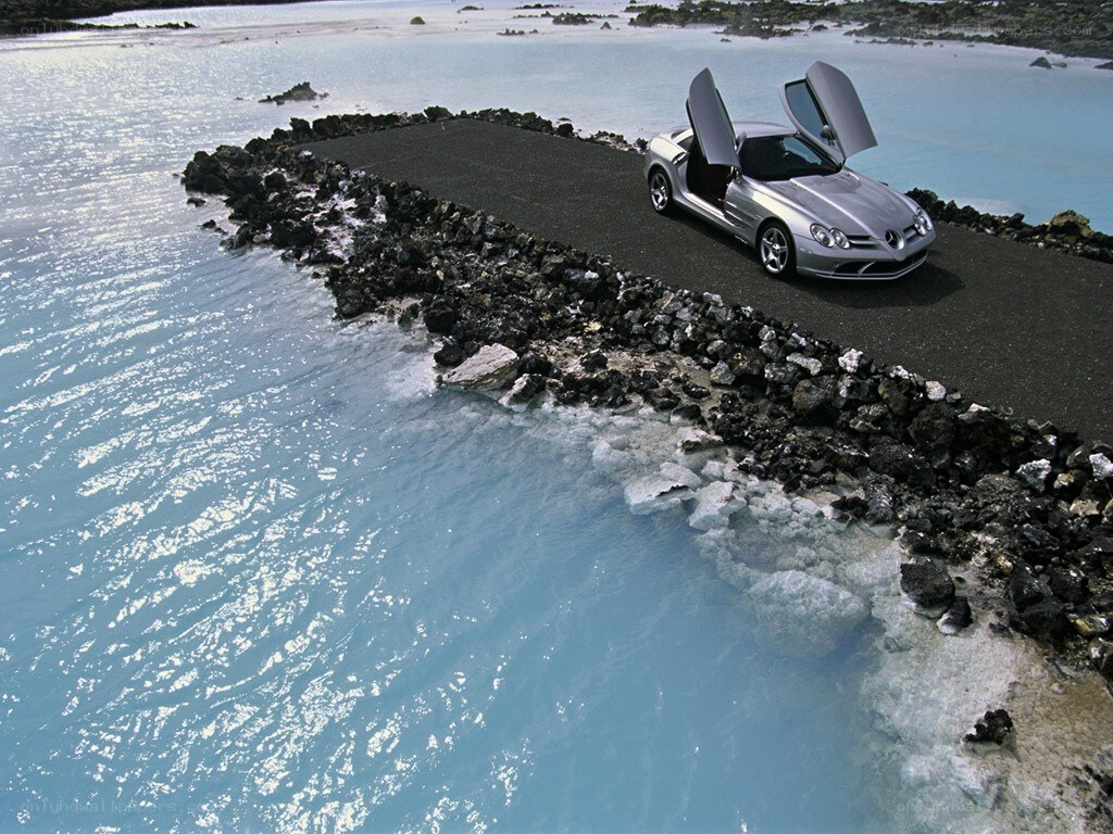 Silver car on a coastal road